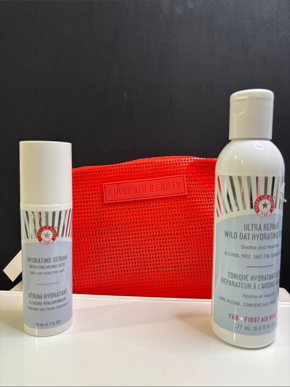 First Aid Beauty White Hydrating Serum & Wild Oat Toner Duo plus bag